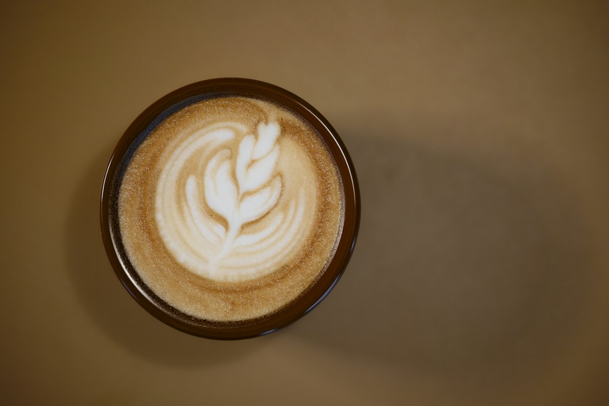 Latte with leaf art, seen from above